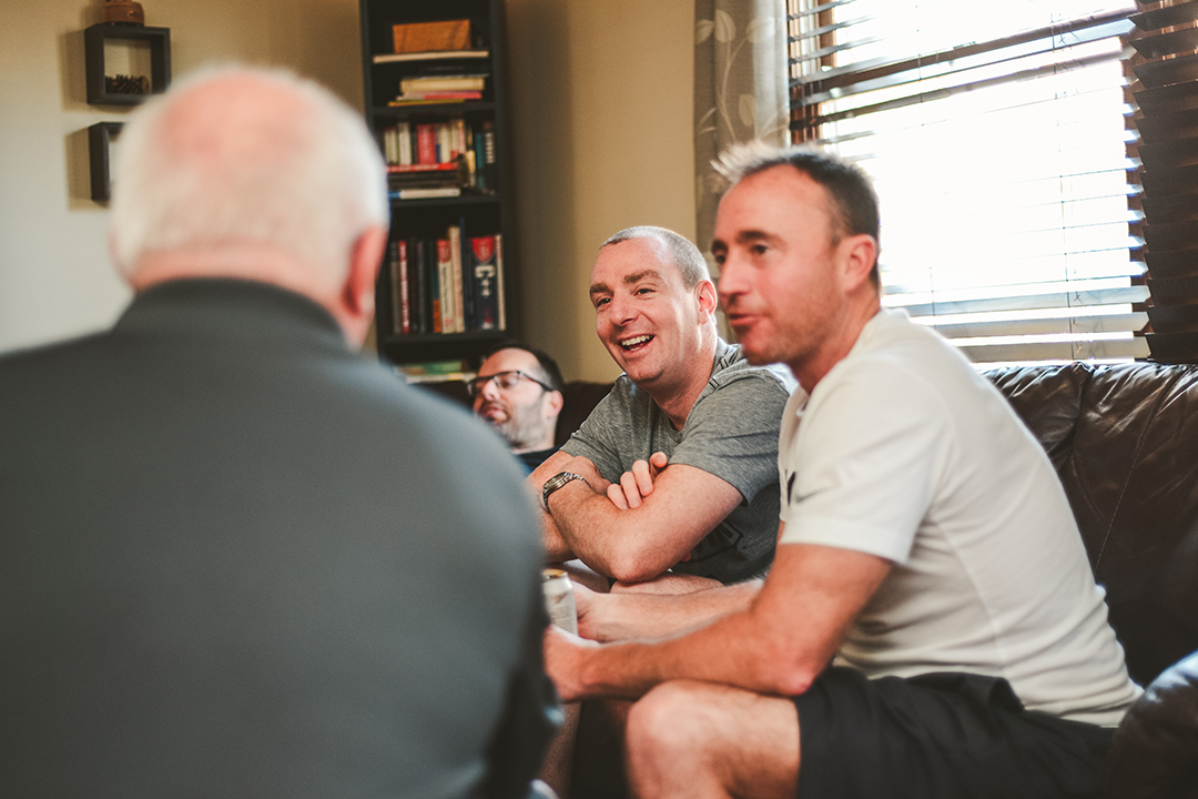 groomsmen talking to grooms father