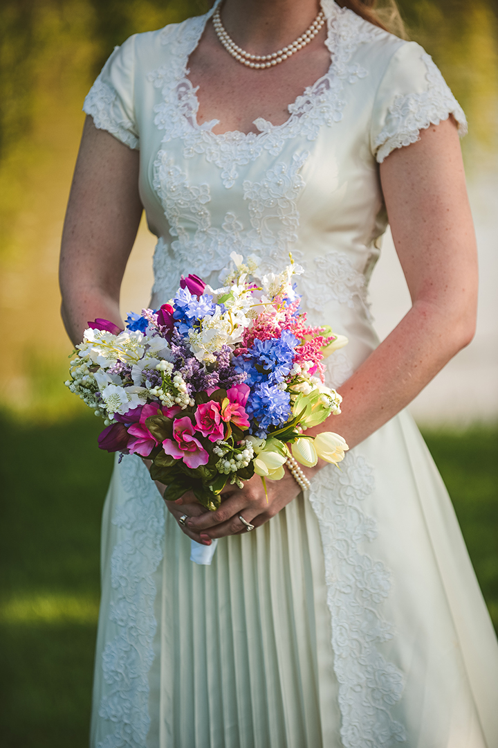 a detail of the brides bouquet at a park 