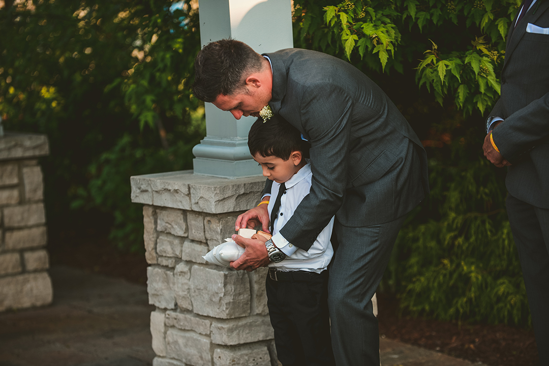 the best man helping the ring barer with the rings