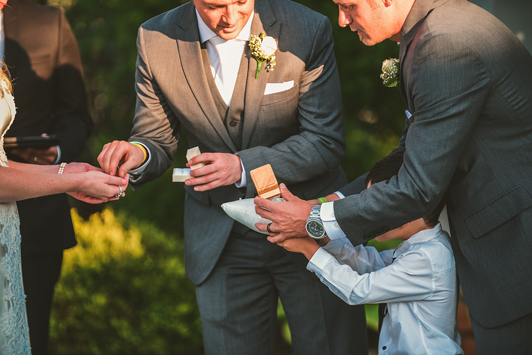 the groom taking the rings from the ring barer 