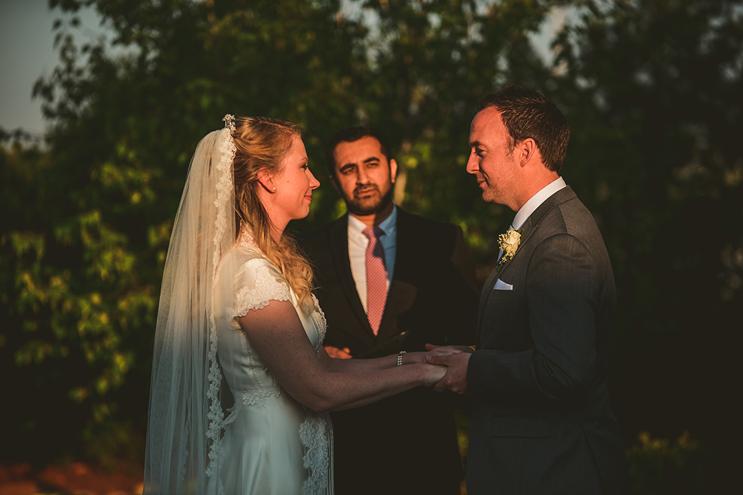 the bride and groom smiling as they look into each others eyes