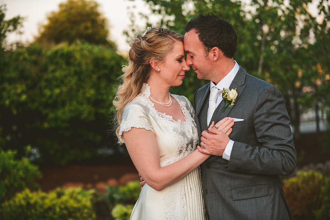 a romantic couple getting close at a wedding