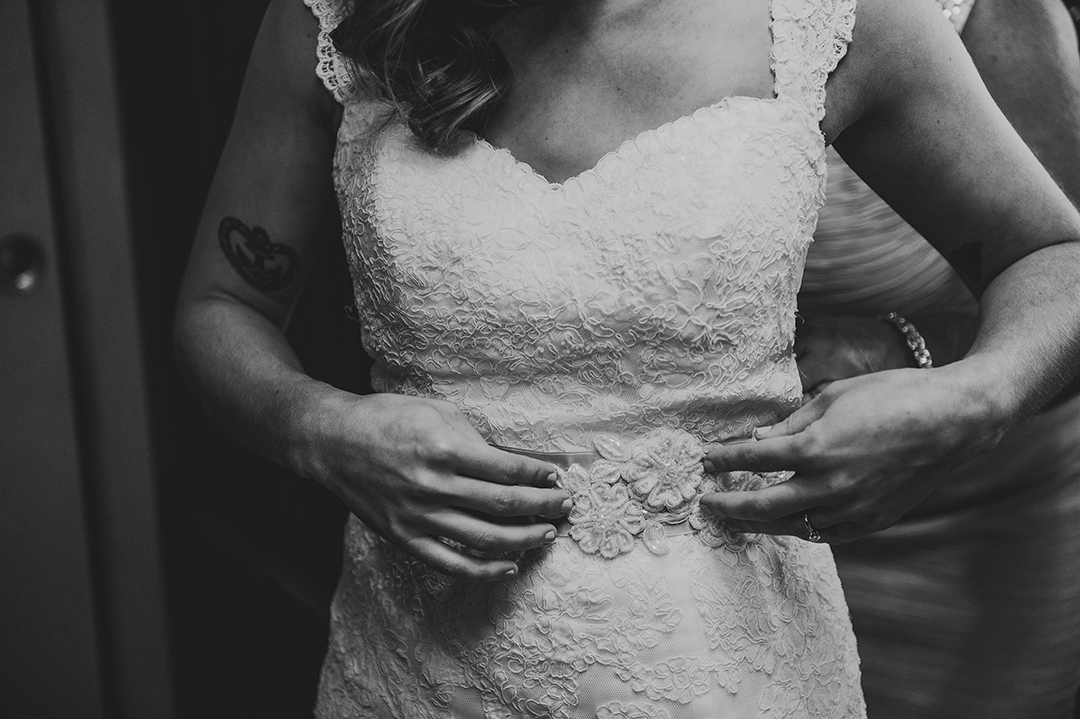 a bride adjusting her dress on her wedding day