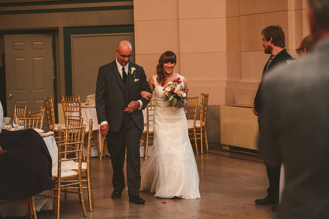 a father walking the bride down an aisle at the Joliet Union Station on her wedding day