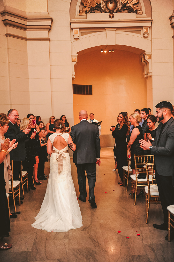 a dad leading the bride towards her waiting groom at the Joliet Union Station