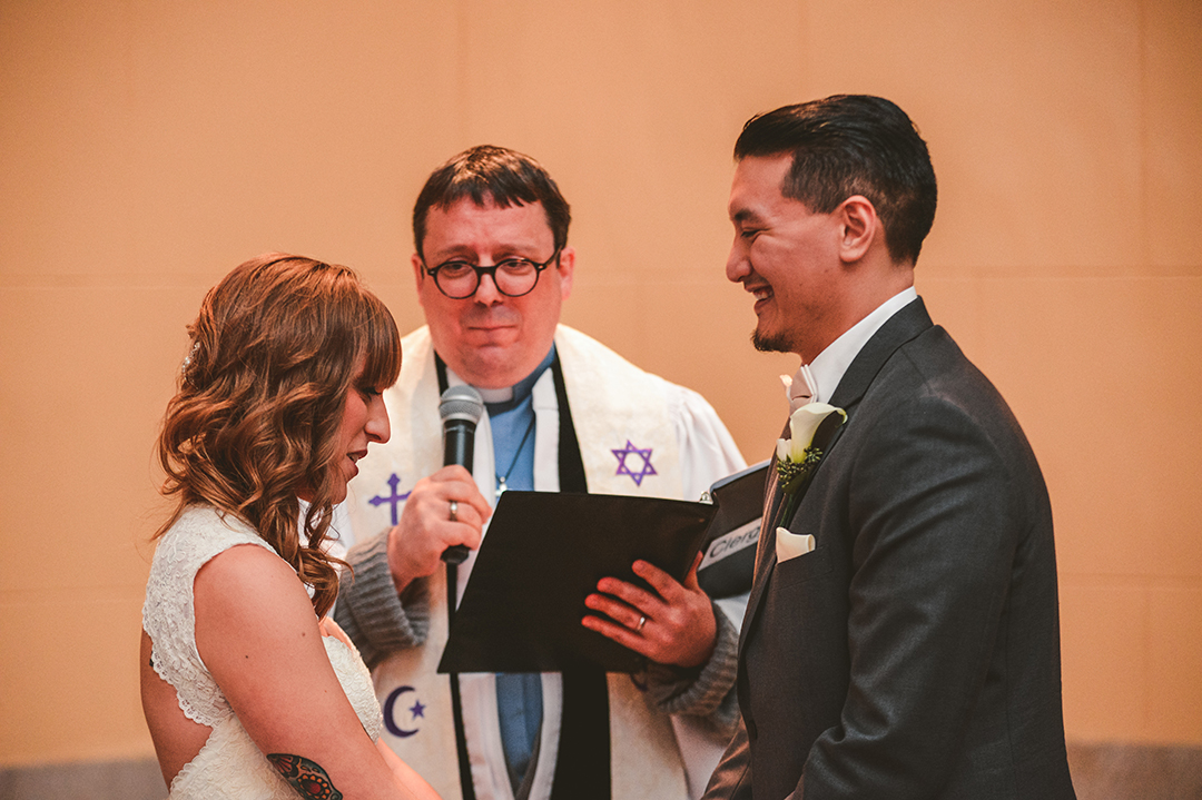 a groom laughing during a wedding ceremony at the Joliet Union Station