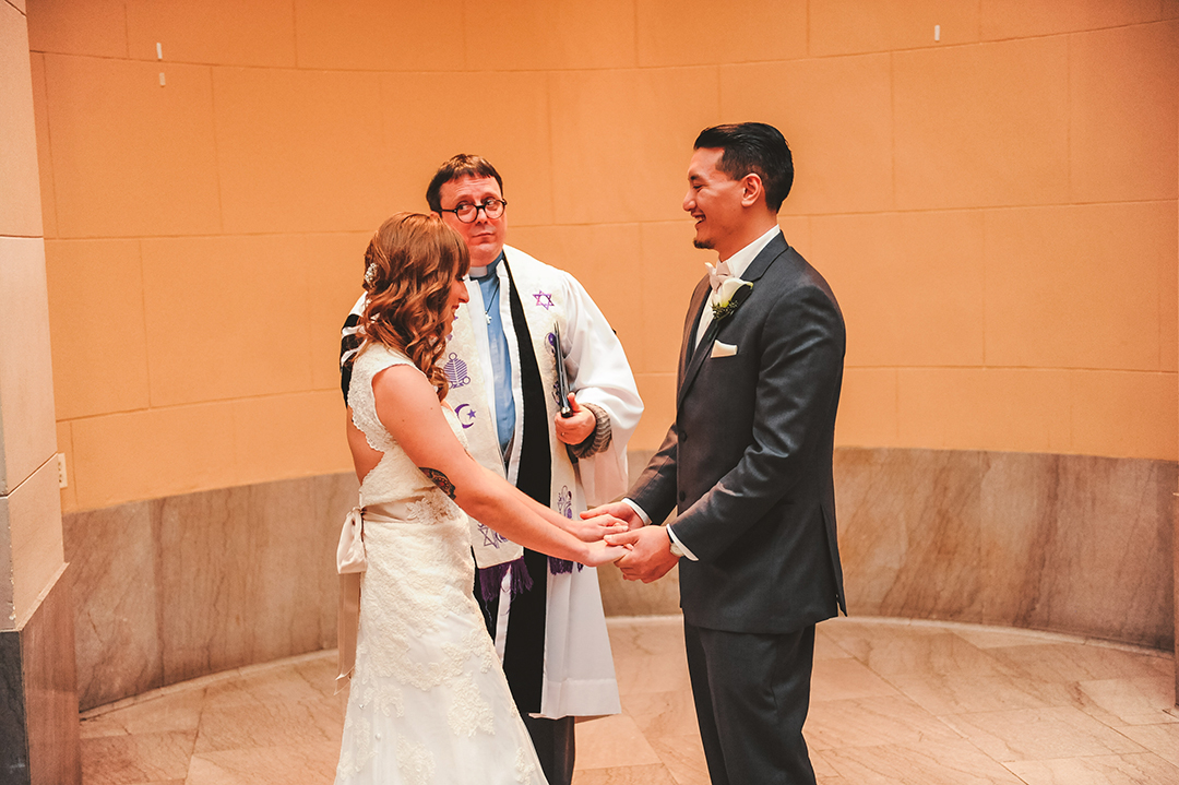 a bride and groom laughing after their first kiss