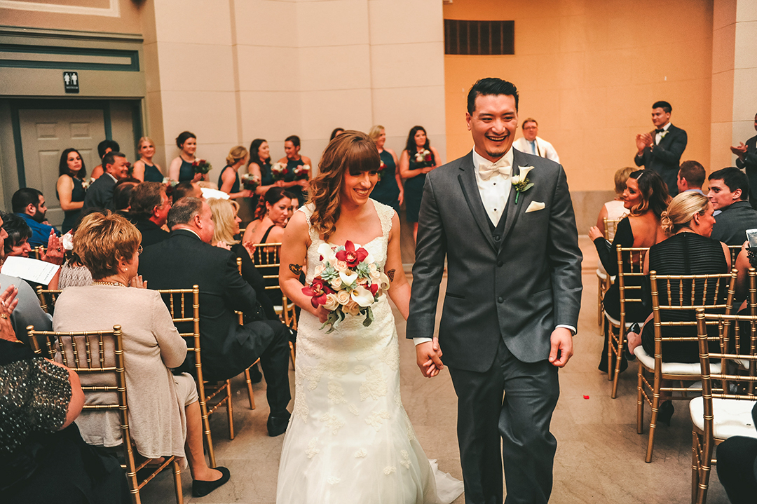 a couple walking down the aisle after getting married at the Joliet Union Station