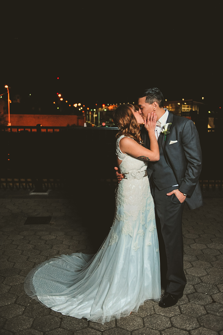 a wedding couple kissing at night after getting married