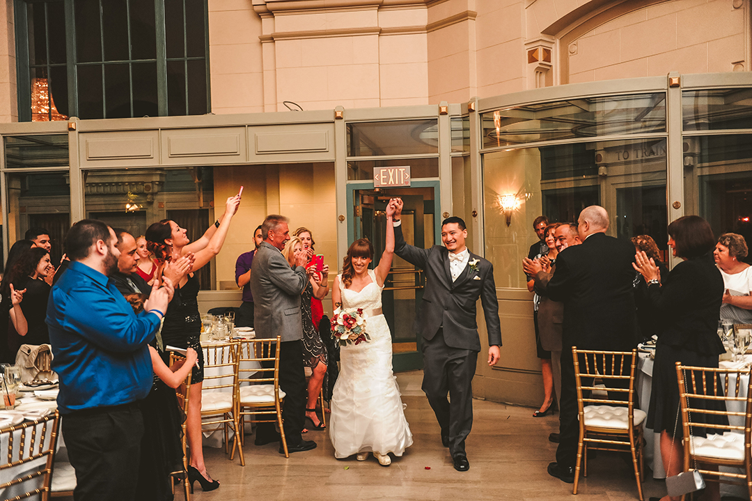 a wedding couple getting introduced into their wedding reception