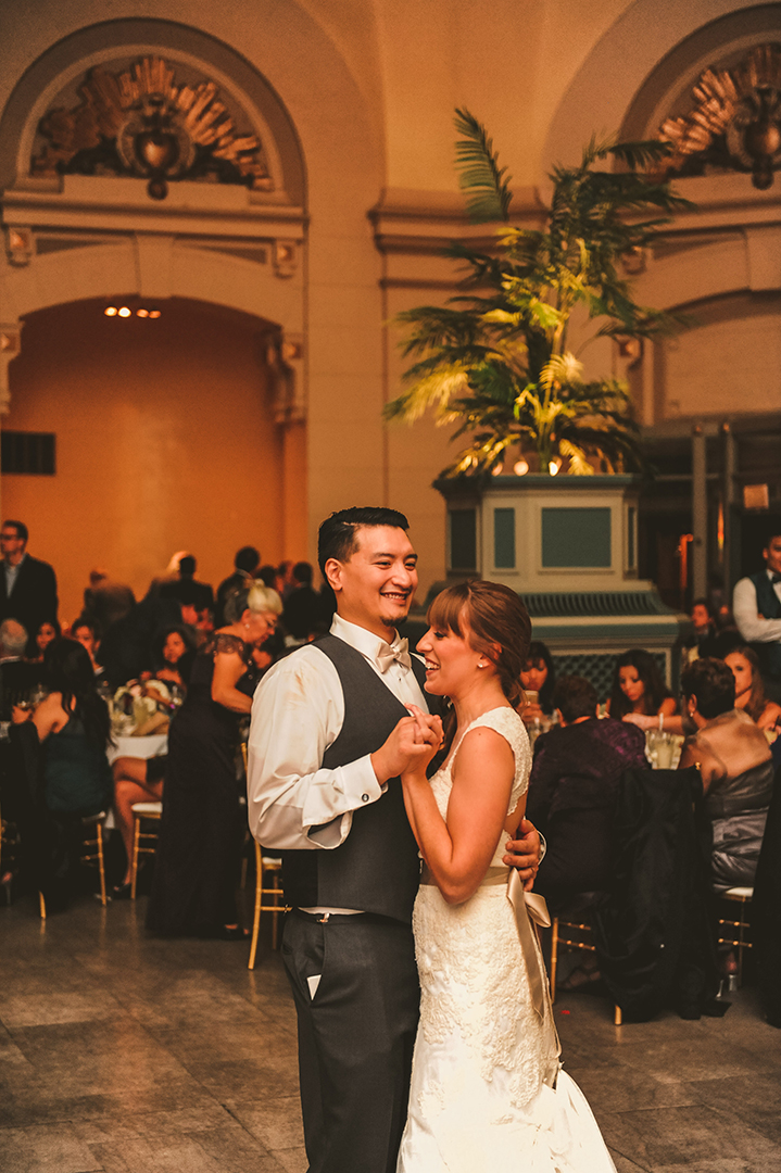 a bride and groom dancing for the first time at the Joliet Union Station