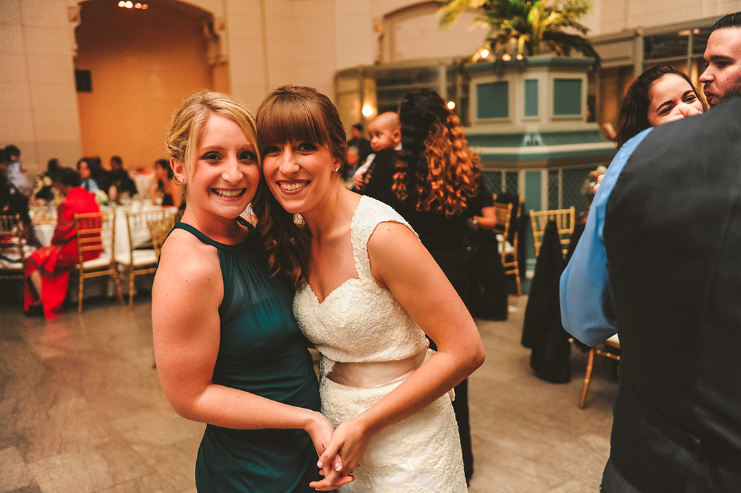 a bride dancing with one of her bridesmaids at her wedding reception