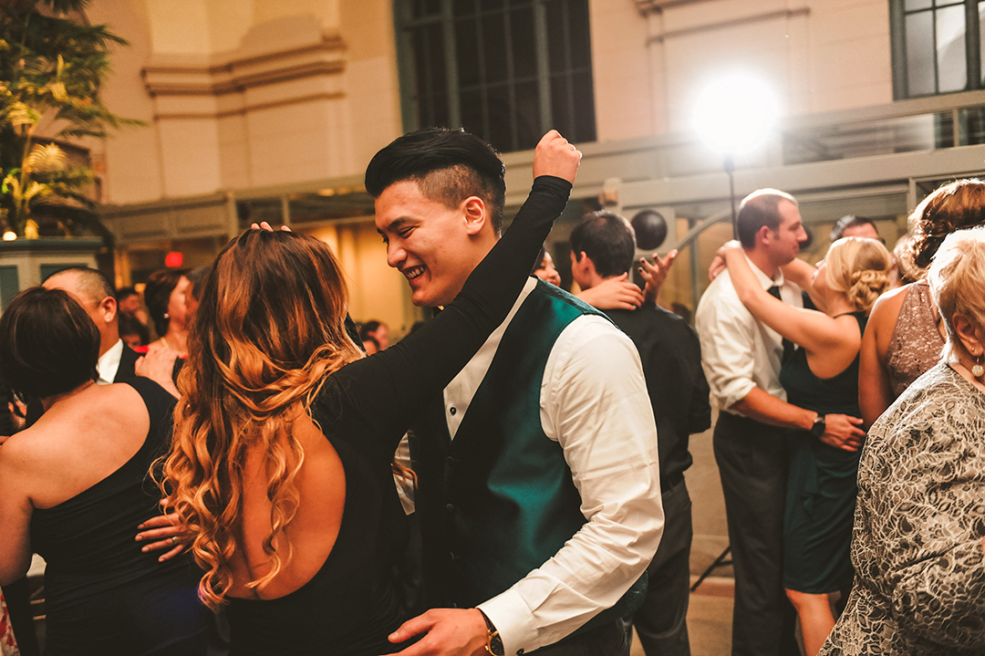 a groomsmen dancing with his girlfriend at the Joliet Union Station