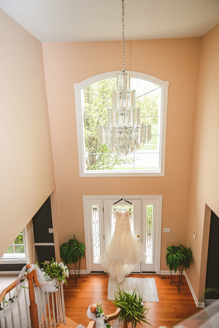 a wedding dress hung in a doorway in Oak Forest