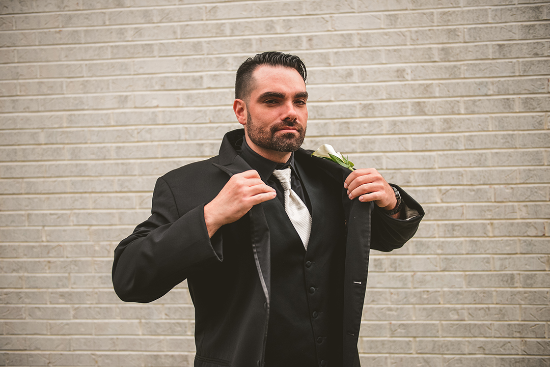 a groom tossing on his jacket in Oak Forest