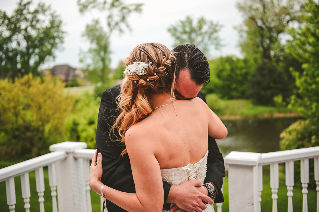 a man hugging his bride as he sees her for the first time