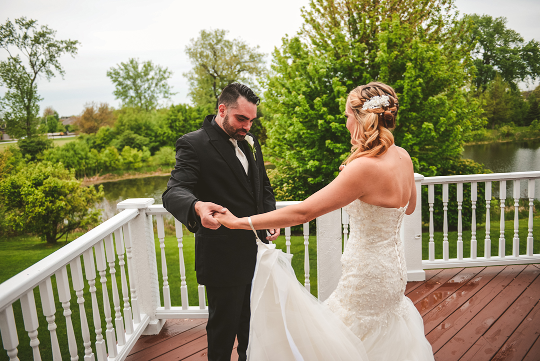 a groom checking out his bride on their deck