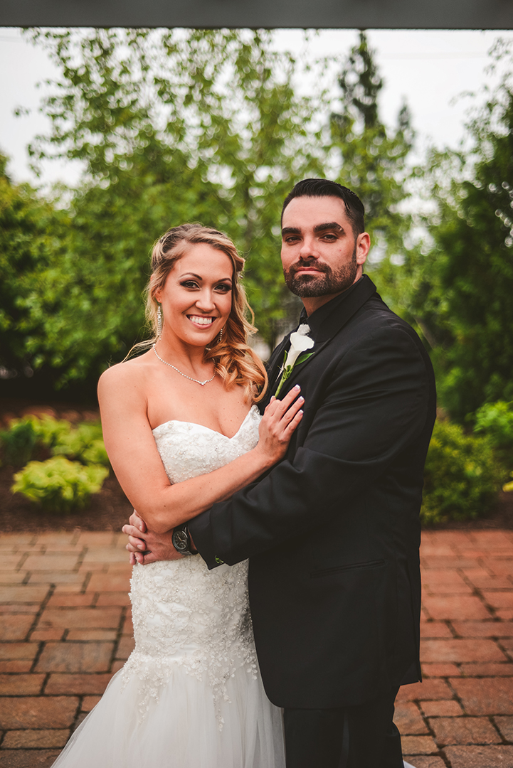 a bride and groom hugging as they smile before their wedding