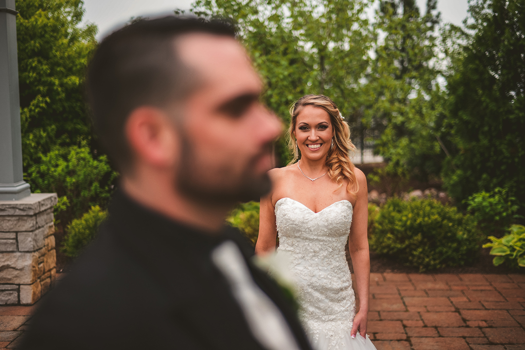 a bride checking out her husband as he looks off into the distance