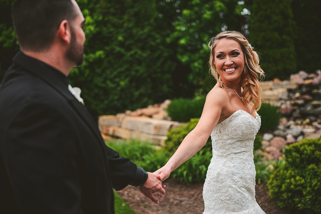 a bride looking back at her groom as they walk