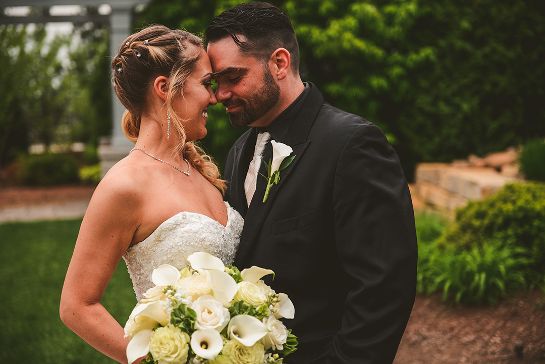 a bride and groom getting close to kiss at Gaelic Park in Oak Forest