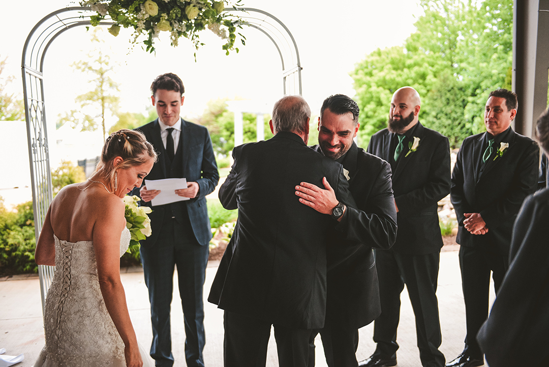 a groom hugging the brides father