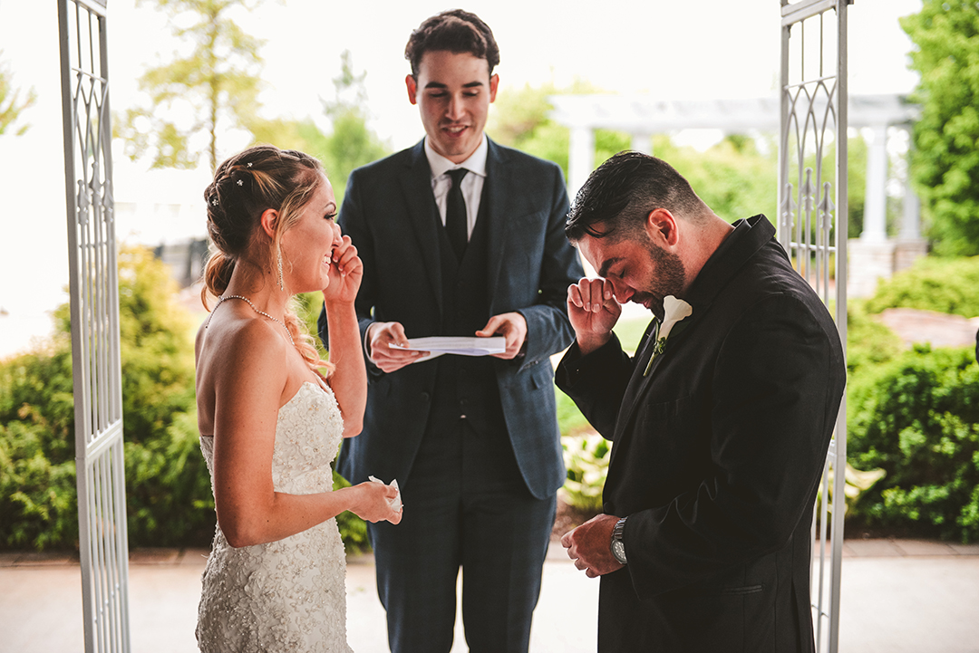 the bride and groom crying as they put on each others rings