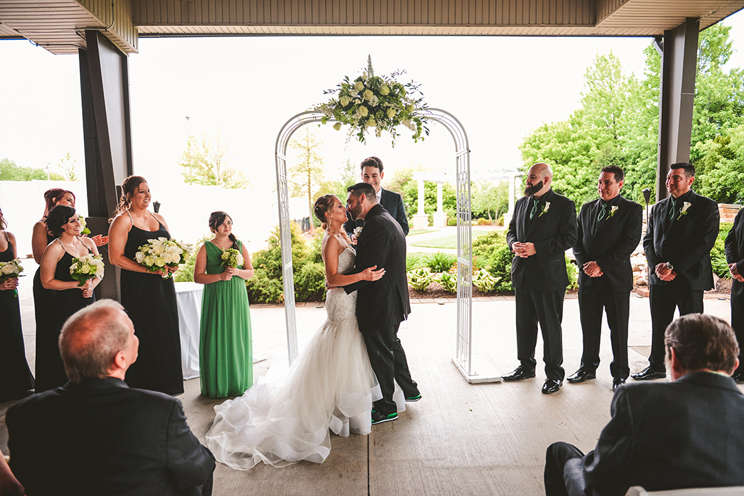 the groom going in for his first kiss during a wedding ceremony