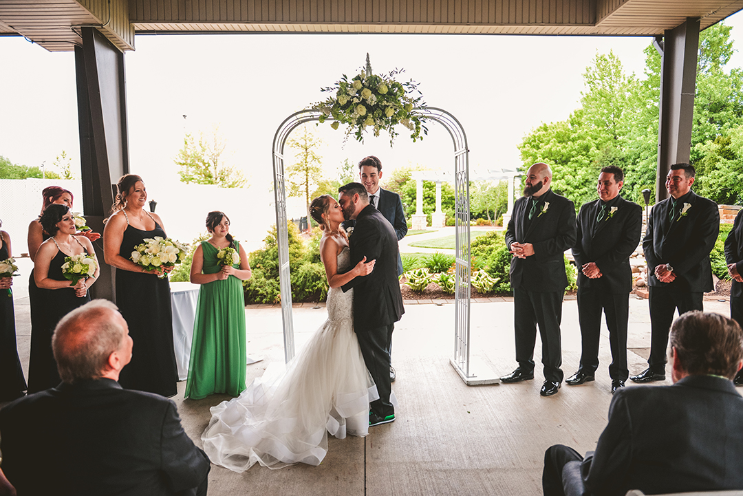 the bride and groom kissing for the first time at their wedding