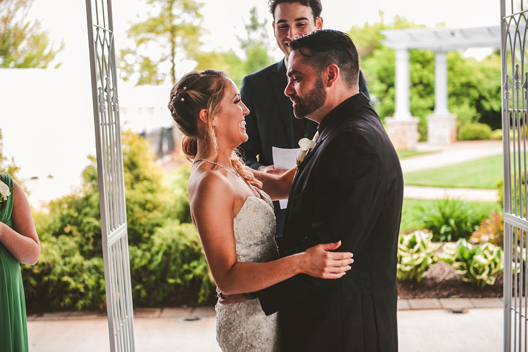 the bride and groom smiling after their first kiss