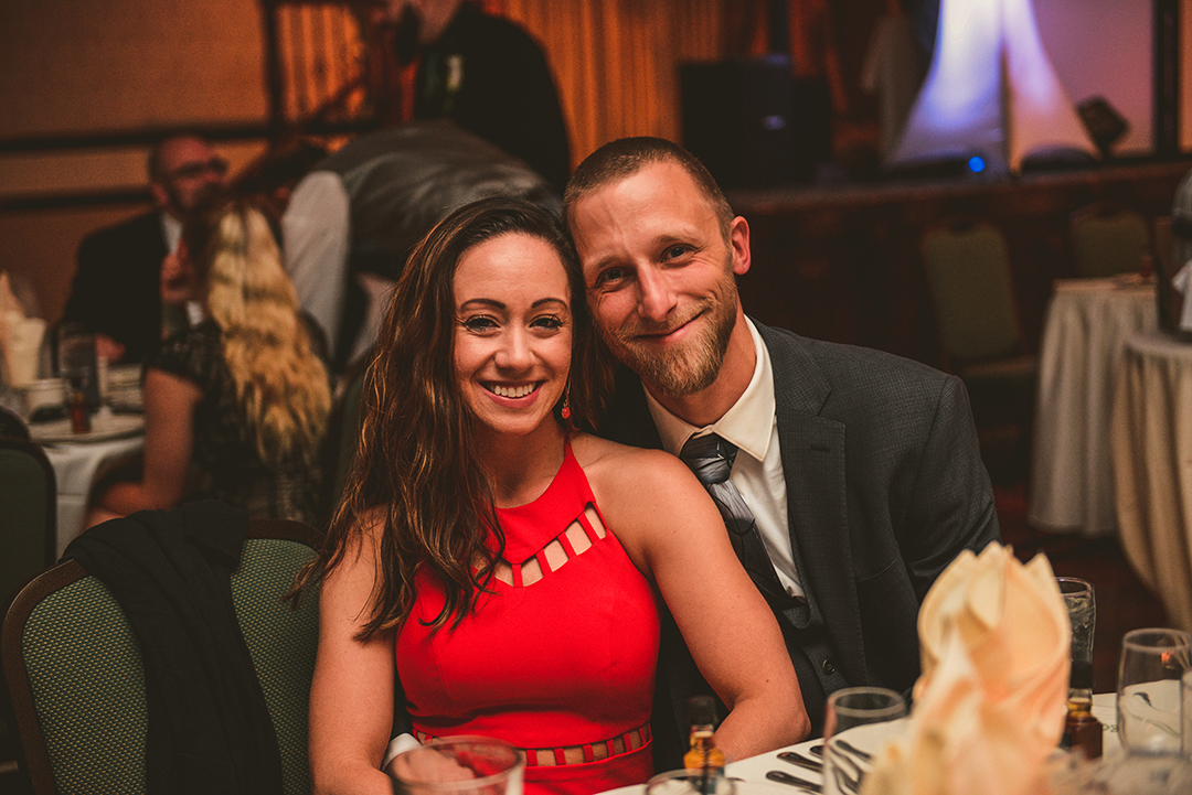 a man and a woman sitting together at a wedding reception