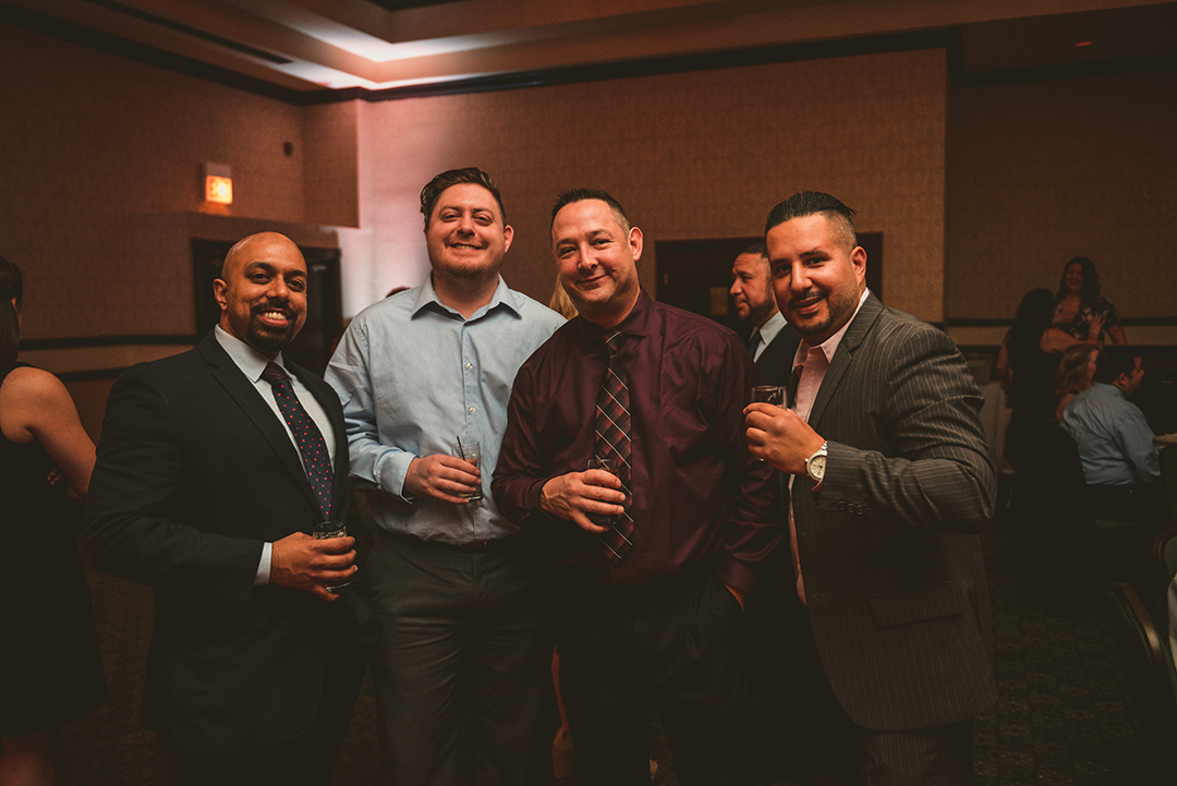 wedding guests standing around talking at a wedding reception