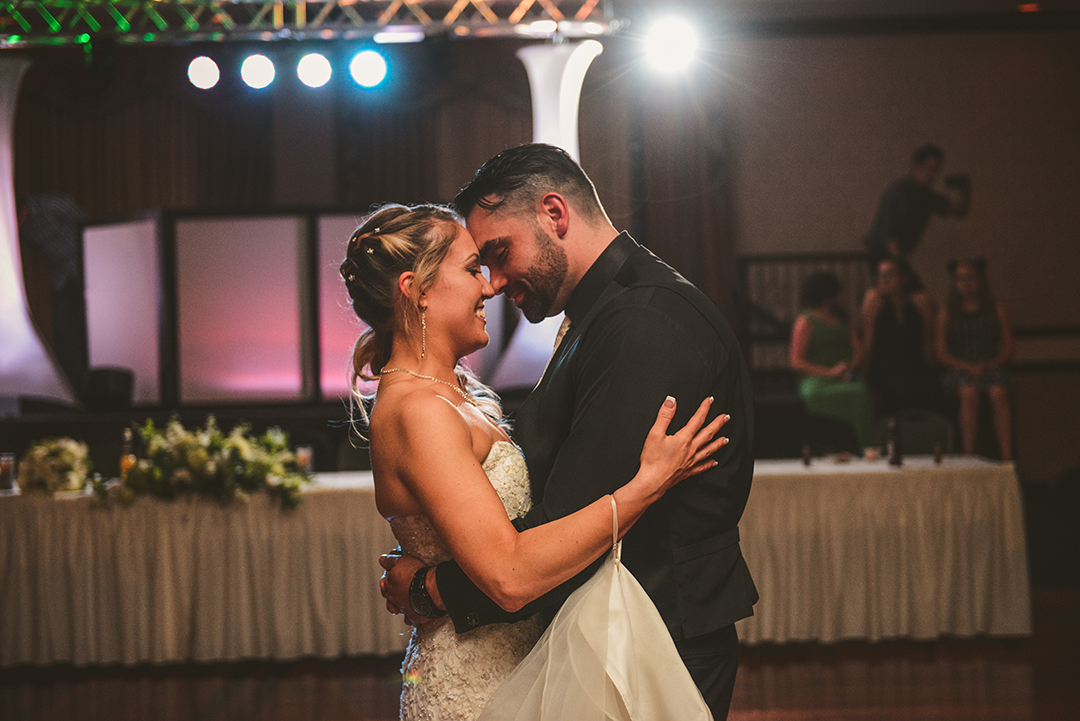 a bride and groom getting close during their first dance