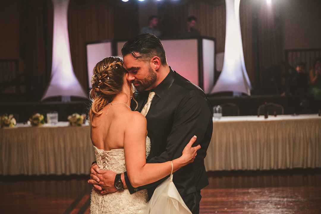 a bride and groom hugging as they dance