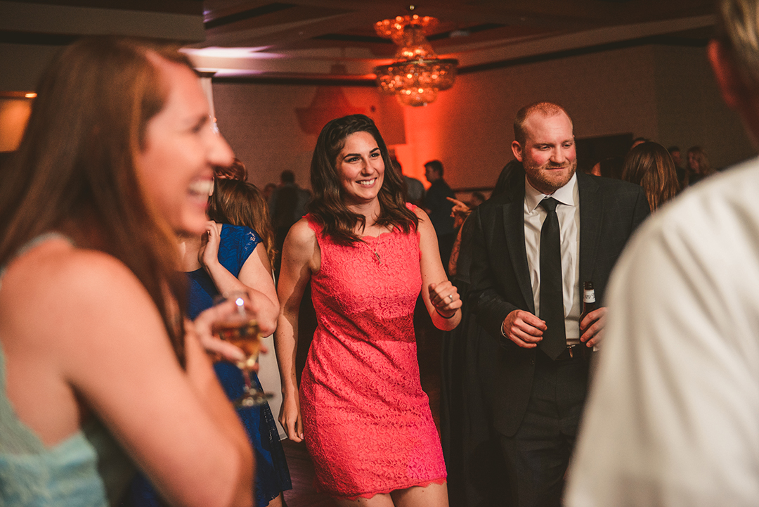 a woman in a pink dress dancing with her friends at Gaelic Park