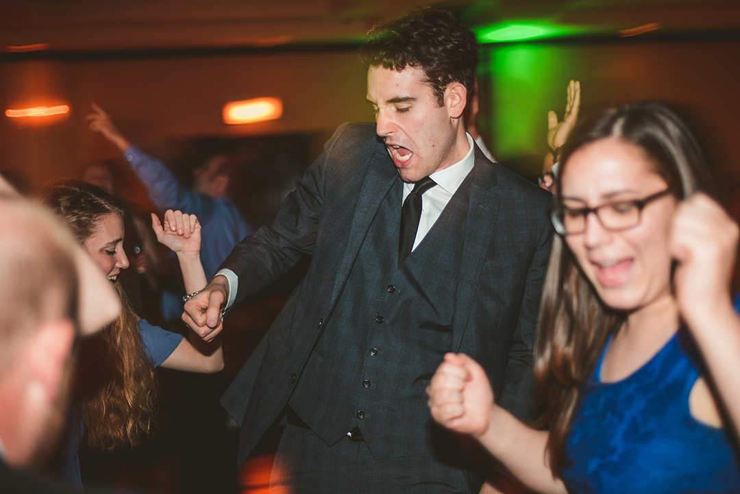 a man dancing with green light in the background with a dragged shutter