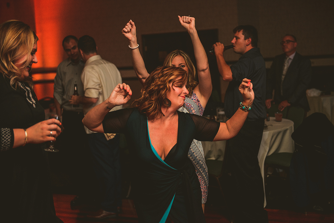 a woman breaking loose on the dance floor at a wedding reception