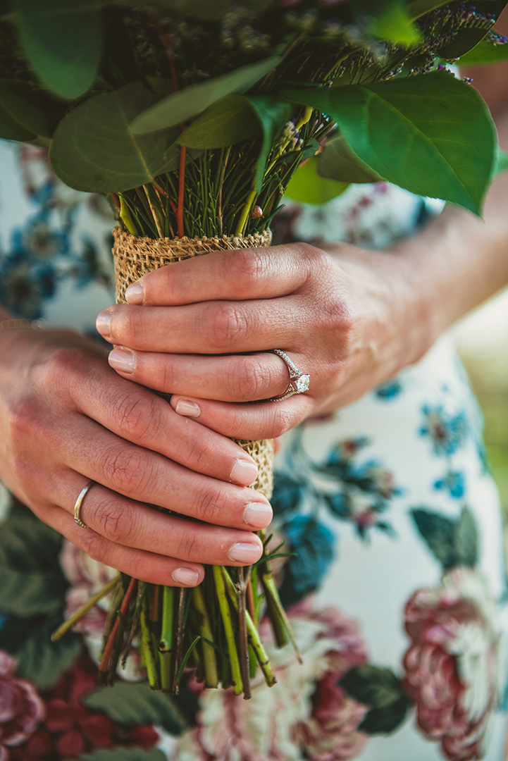 a beautiful sparkly ring as the bride holds onto her bouquet