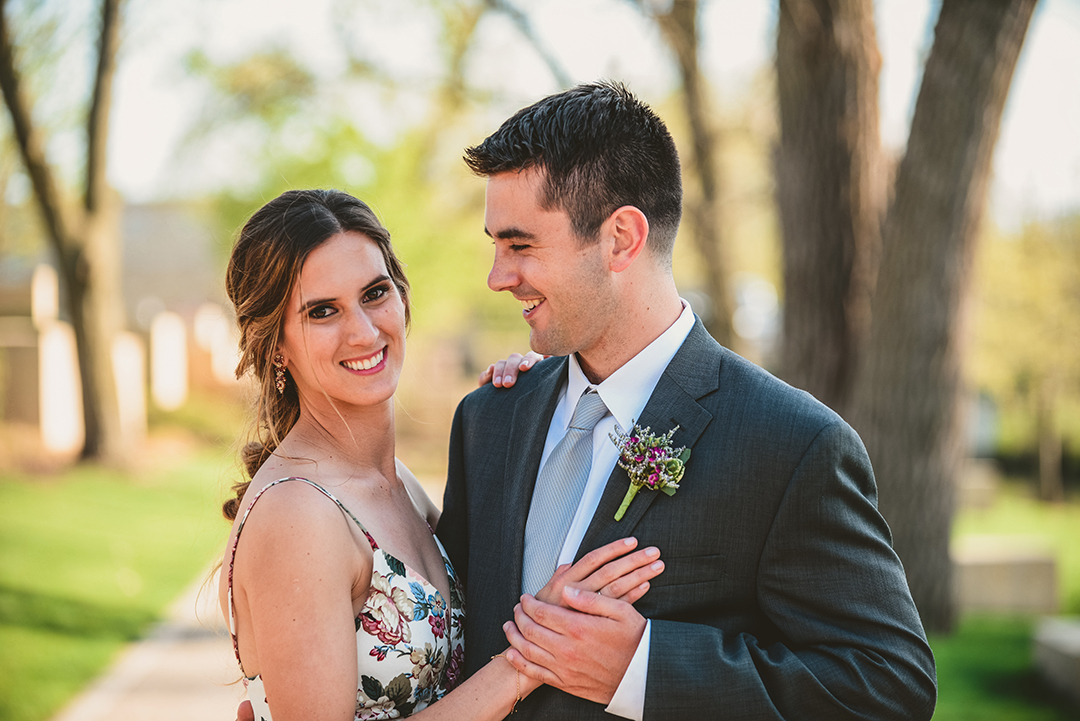 a beautiful bride smiling as her groom looks at her