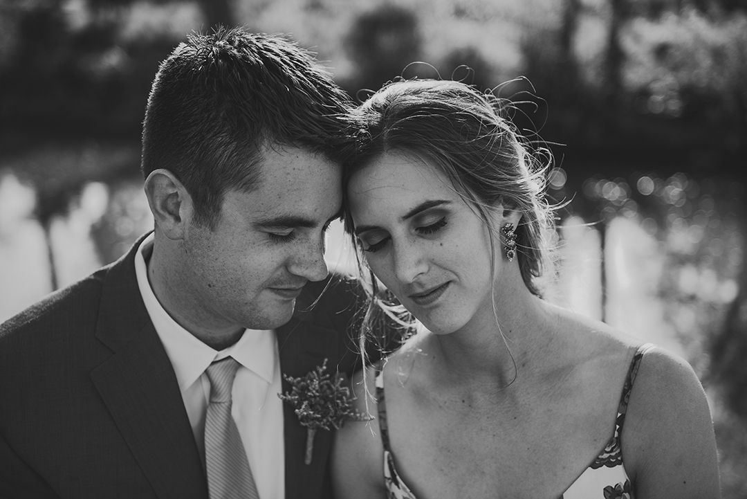 a moody B & W of a bride and groom with their heads together