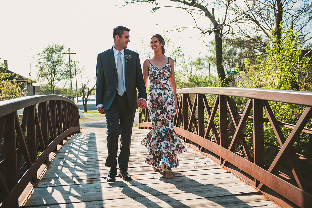 a man and a woman walking down a old bridge in Lockport