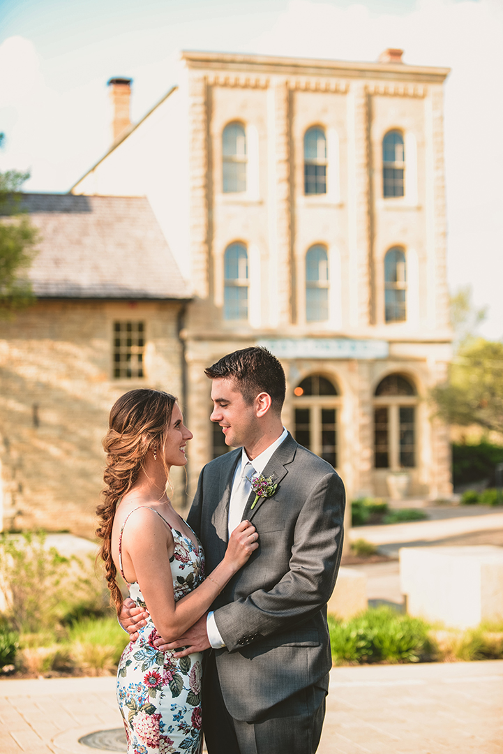 a husband and wife standing in front of the historic gaylord building in Lockport