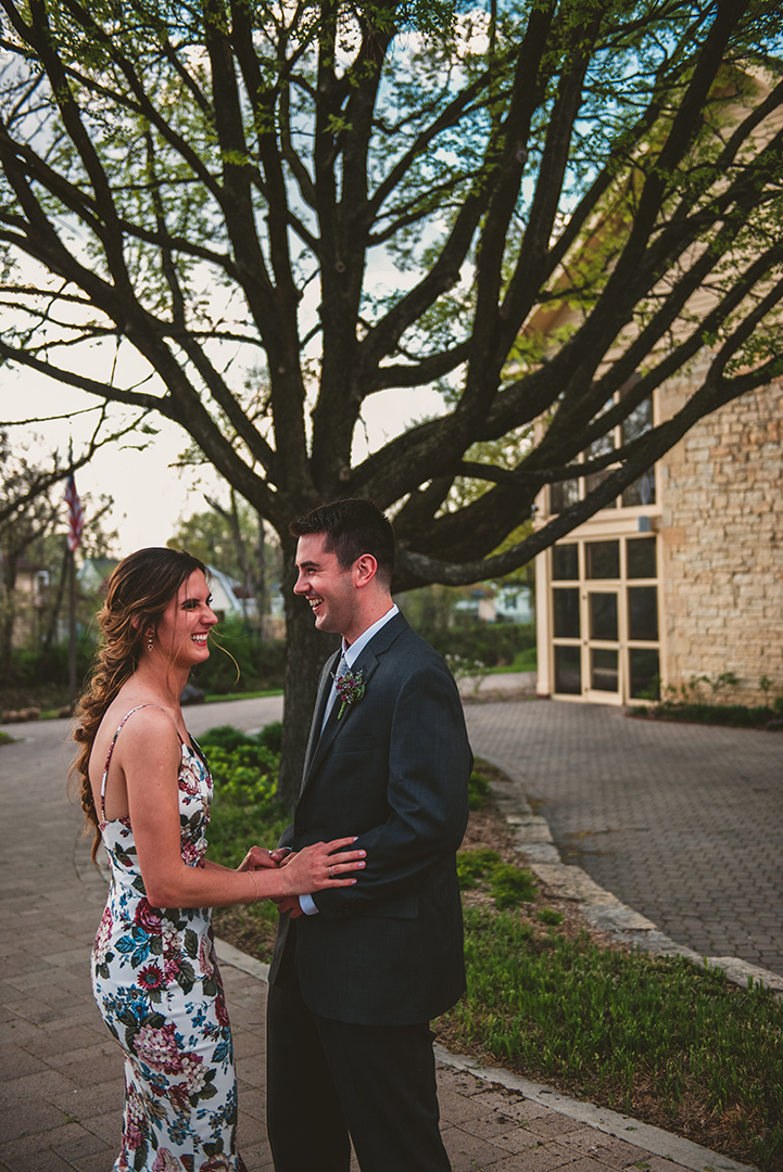 a wedding couple laughing in front of an old tree in Chicago