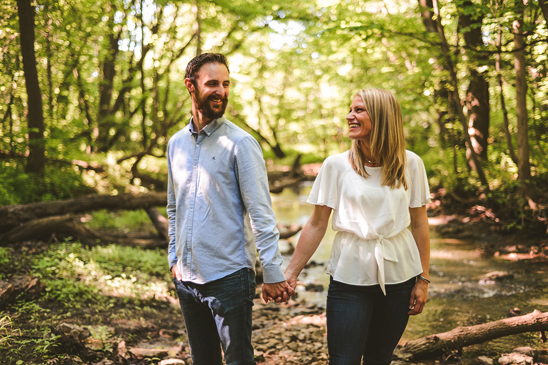 a man and a woman in Hammel Woods holding hands