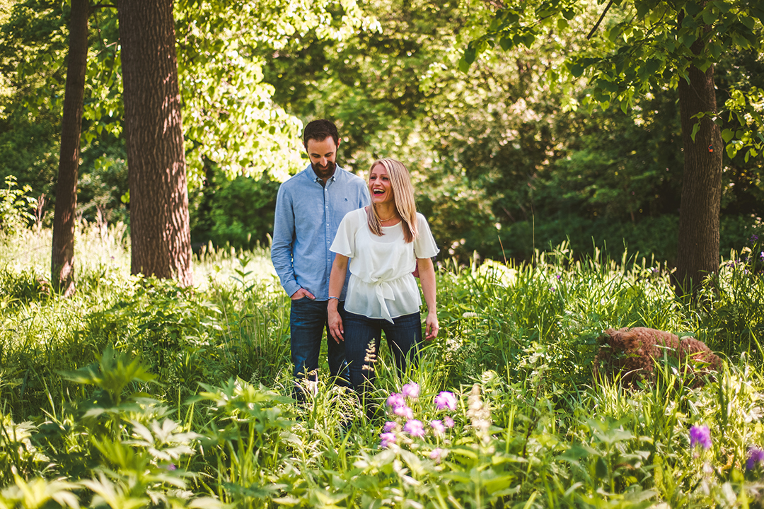 an outtake of a woman laughing as a dog runs into an engagement photo