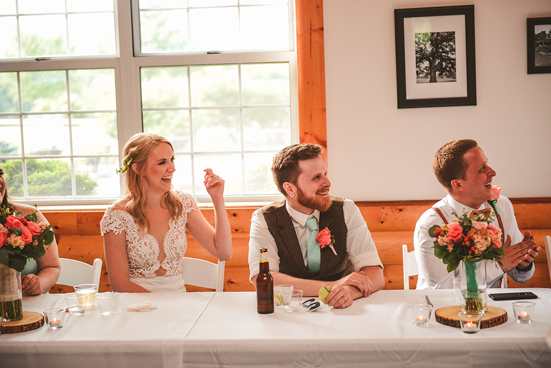 the bride and groom laughing as the best man gives his speech in Woodstock IL