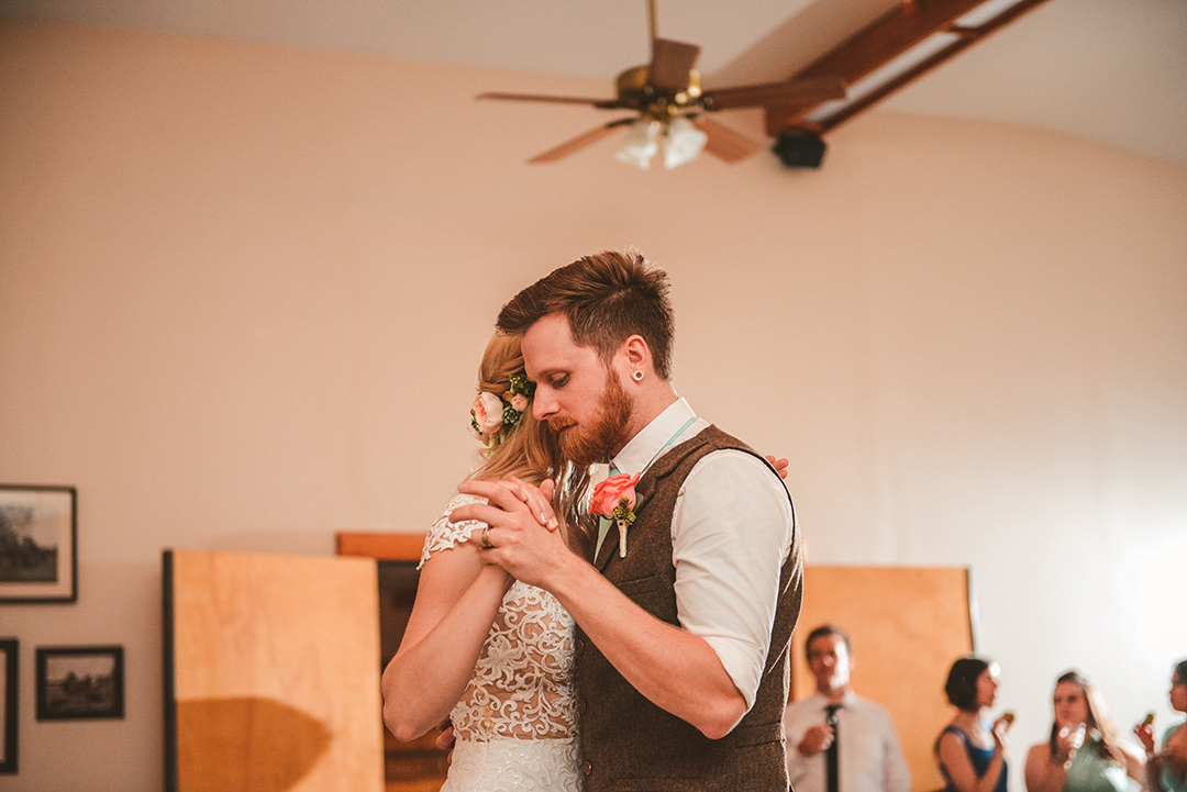 a romantic image of a man and woman experiencing their first dance in a vintage barn in Woodstock IL