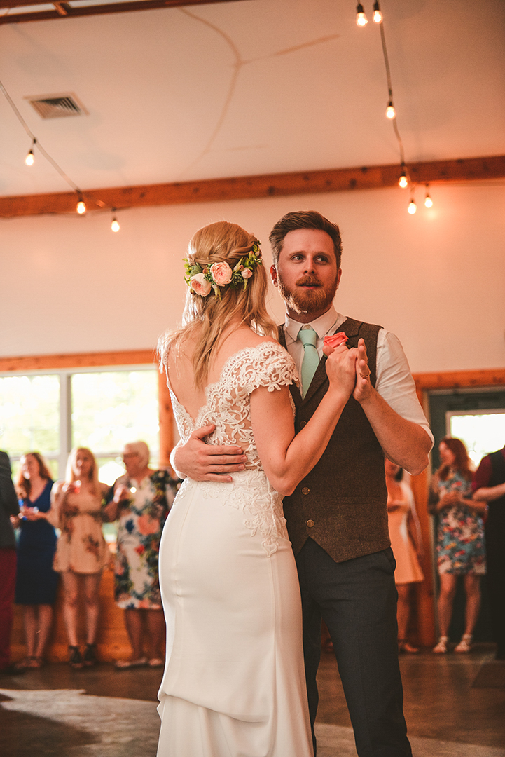 a husband and wife dancing during their first dance in an old barn in Woodstock IL