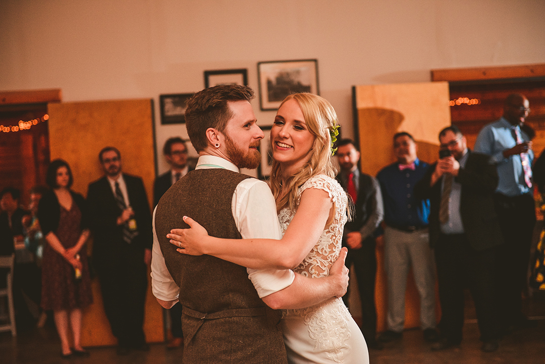 a husband and wife laughing as they dance during their first dance at the All Season Orchard in Woodstock IL