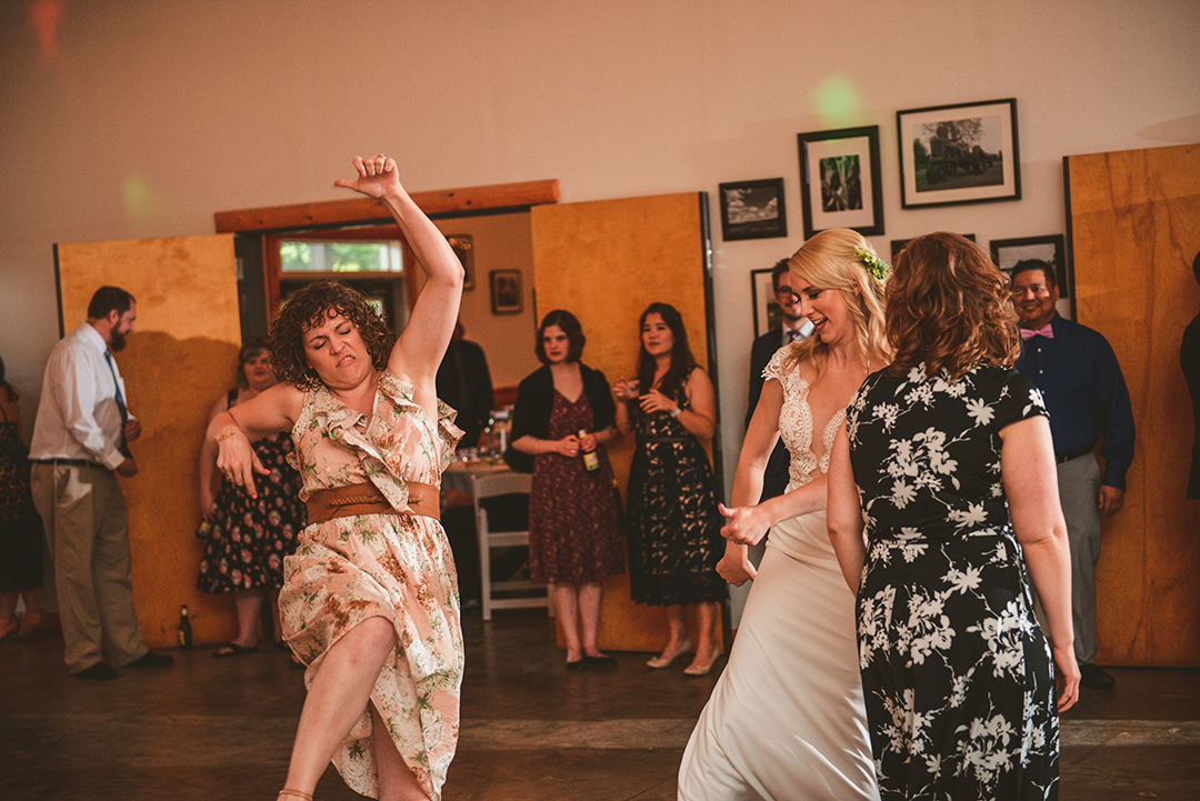 a friend of the bride dancing hilariously with her friends at a wedding reception in Woodstock IL